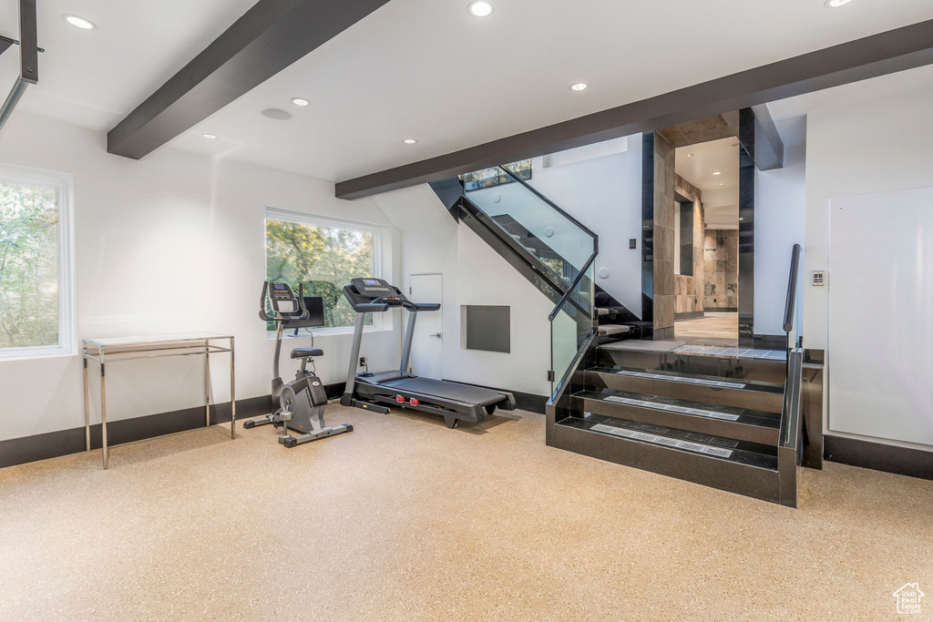 Exercise area with recessed lighting and baseboards