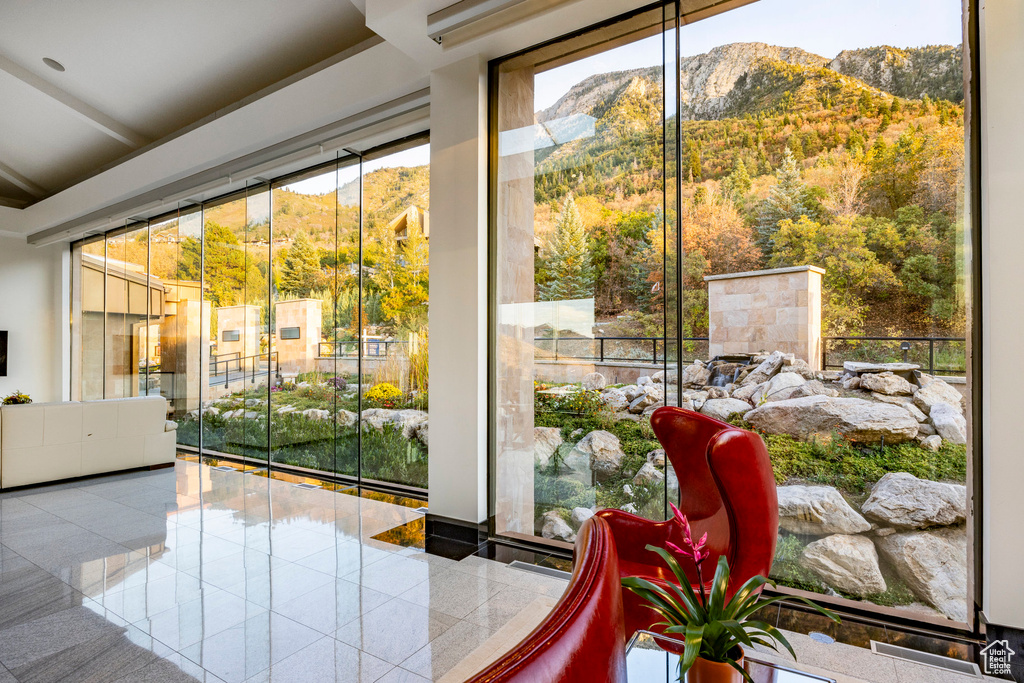 Entryway featuring a mountain view, tile patterned floors, and a healthy amount of sunlight