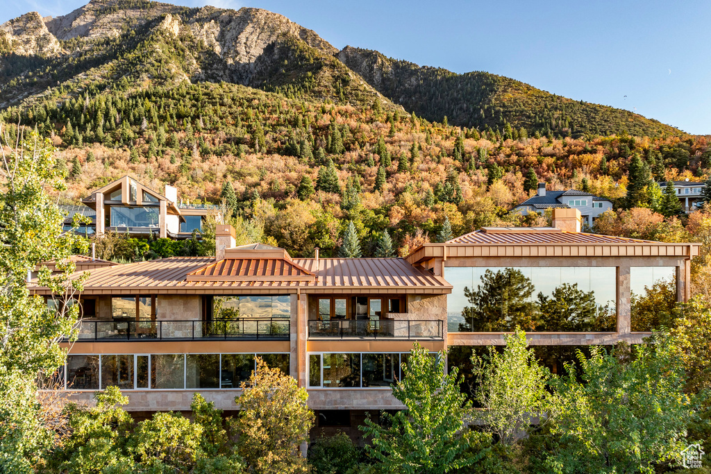 View of mountain backdrop featuring a heavily wooded area