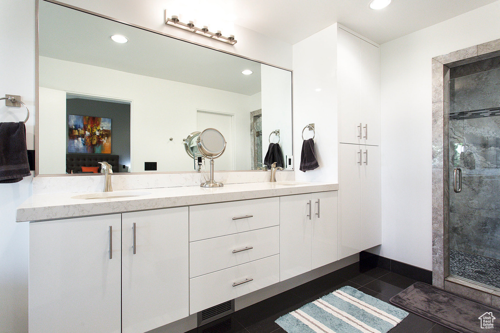 Bathroom with tile patterned floors, vanity, and a shower with shower door