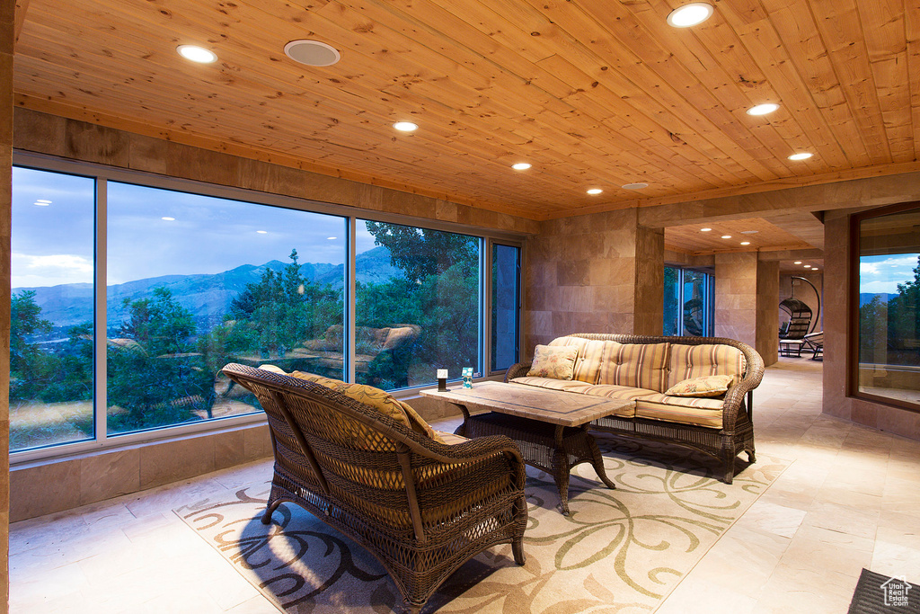 Living room with wooden ceiling, a mountain view, and recessed lighting