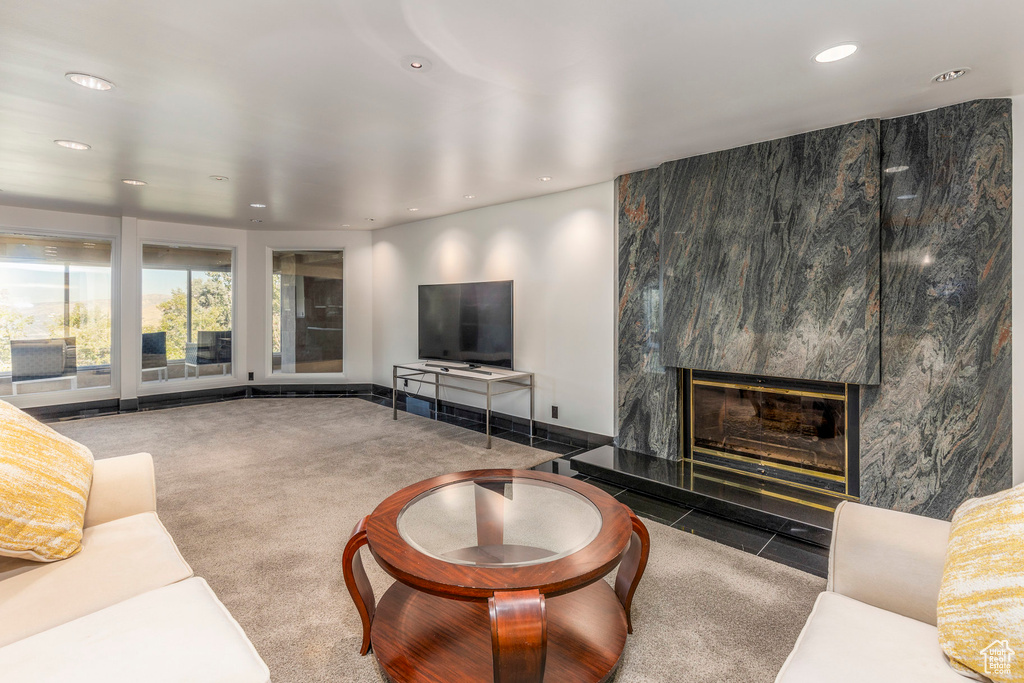 Living room with a premium fireplace and carpet flooring