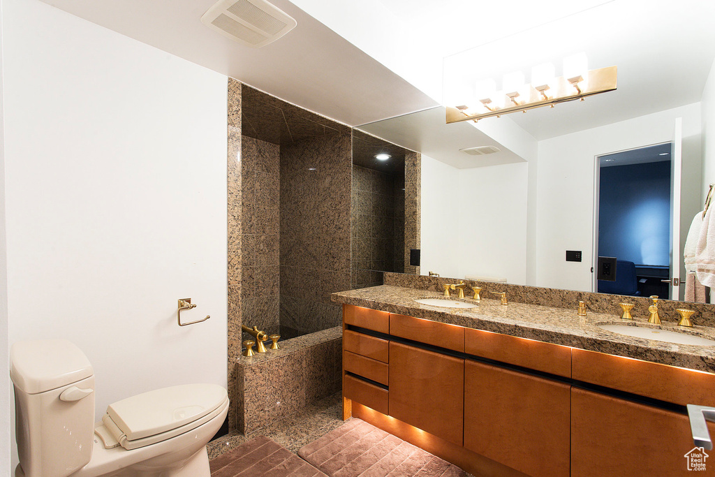 Full bathroom with shower with separate bathtub, vanity, and toilet