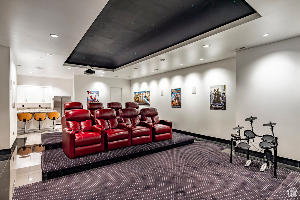 Carpeted cinema featuring recessed lighting, a raised ceiling, and baseboards