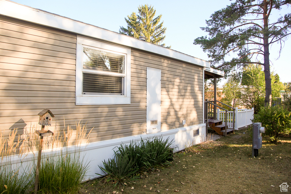 View of side of home featuring a lawn