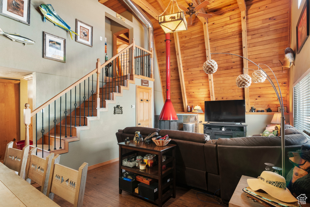 Living room with beam ceiling, hardwood / wood-style floors, high vaulted ceiling, and wooden ceiling