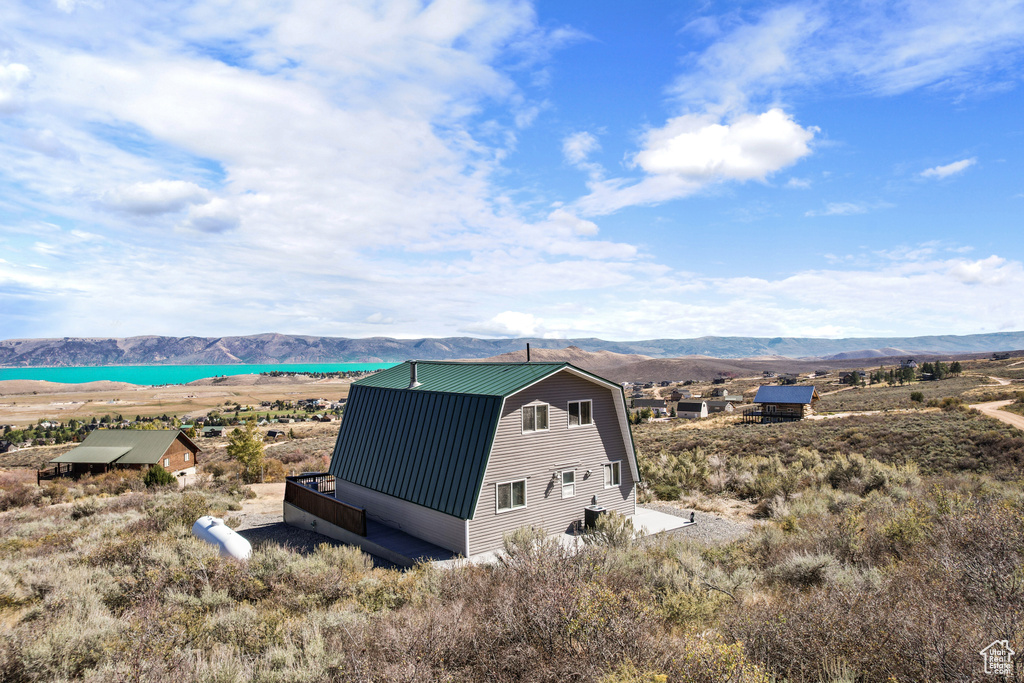 Aerial view featuring a water and mountain view