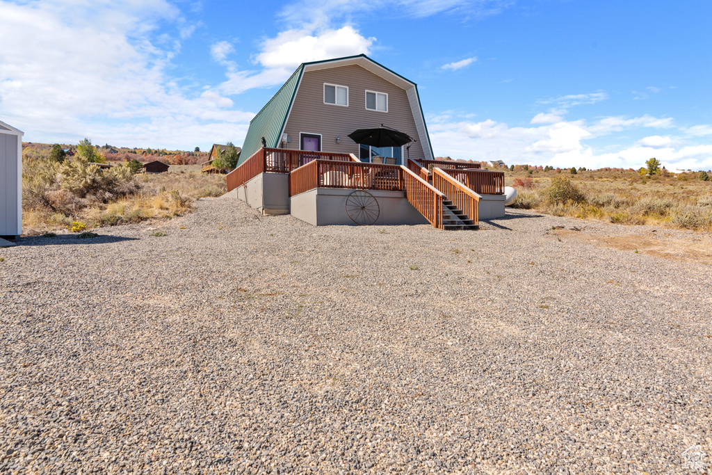 View of front of property with a wooden deck