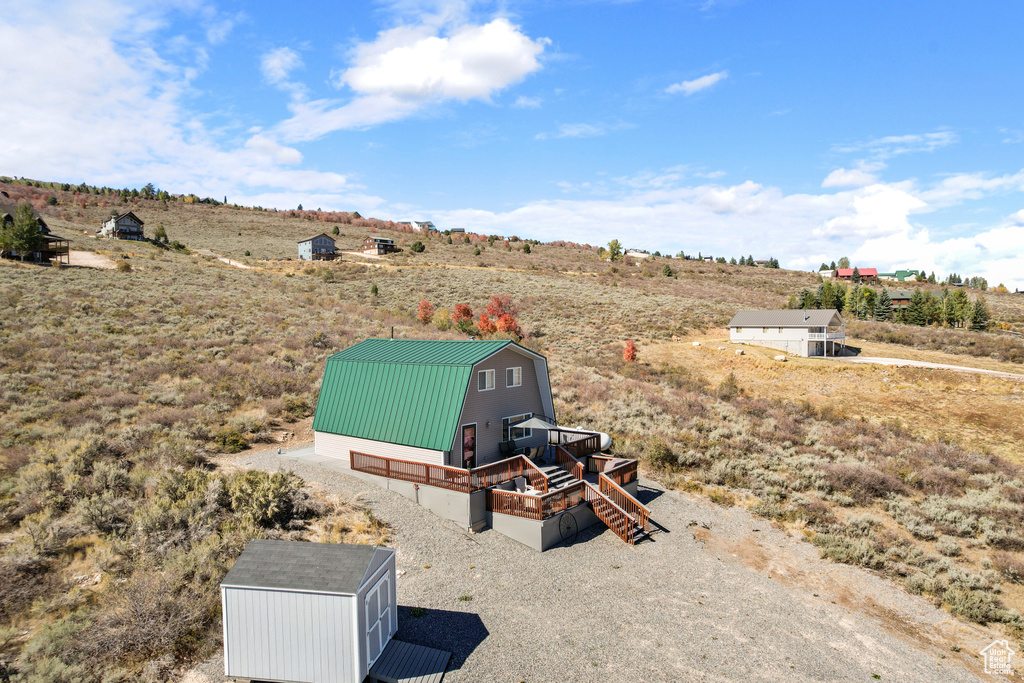 View of yard with a shed and a rural view