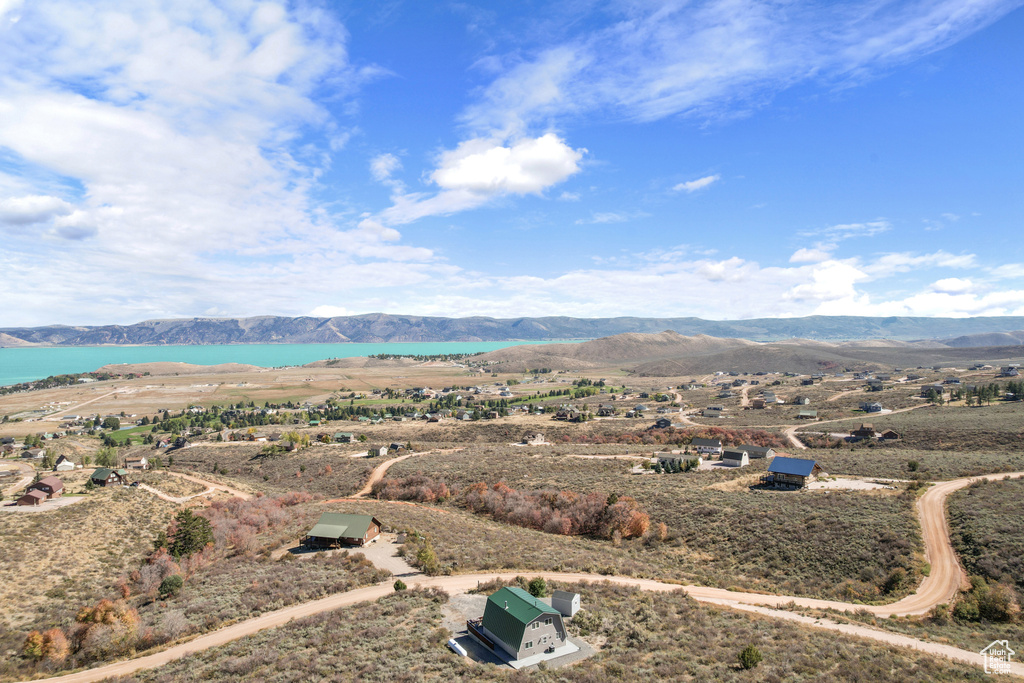 Birds eye view of property with a water and mountain view