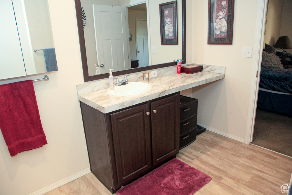 Bathroom with vanity and hardwood / wood-style floors