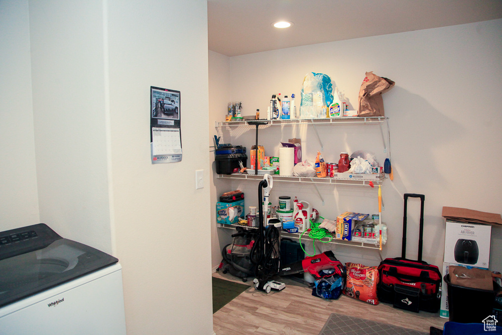 Clothes washing area with washer / dryer and hardwood / wood-style flooring