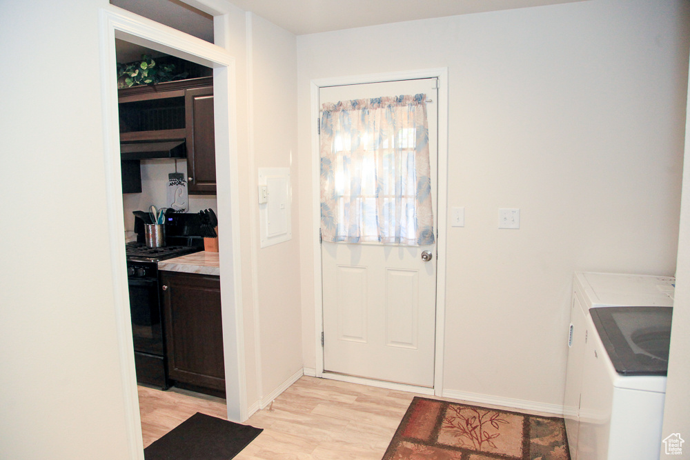 Entryway featuring light hardwood / wood-style flooring and washer and dryer