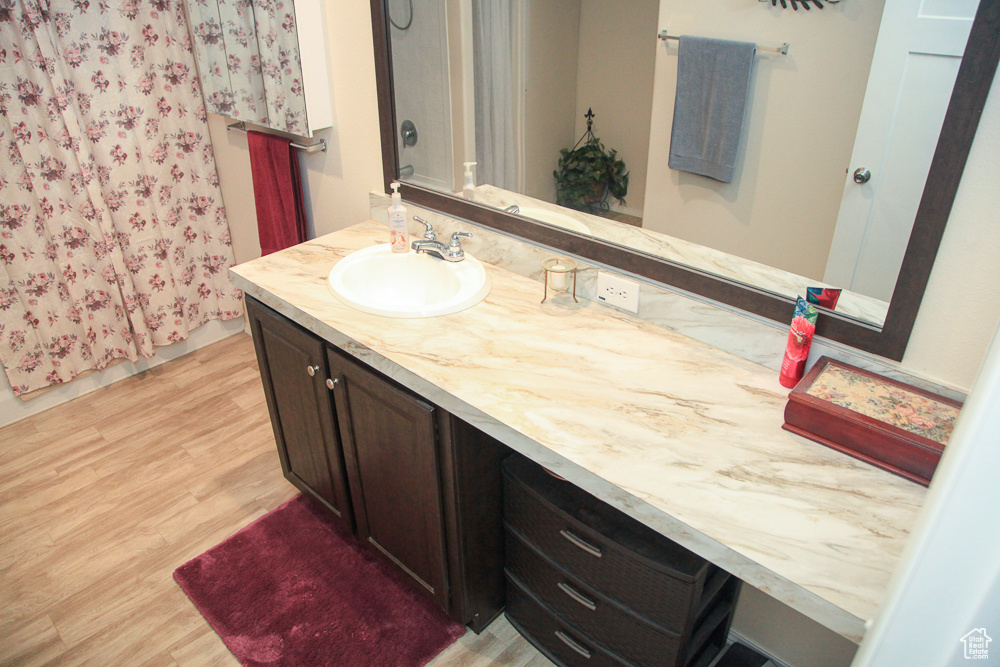 Bathroom with vanity and hardwood / wood-style flooring