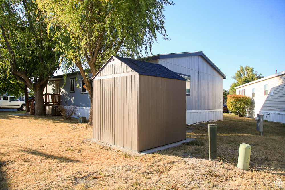 View of outdoor structure with a lawn