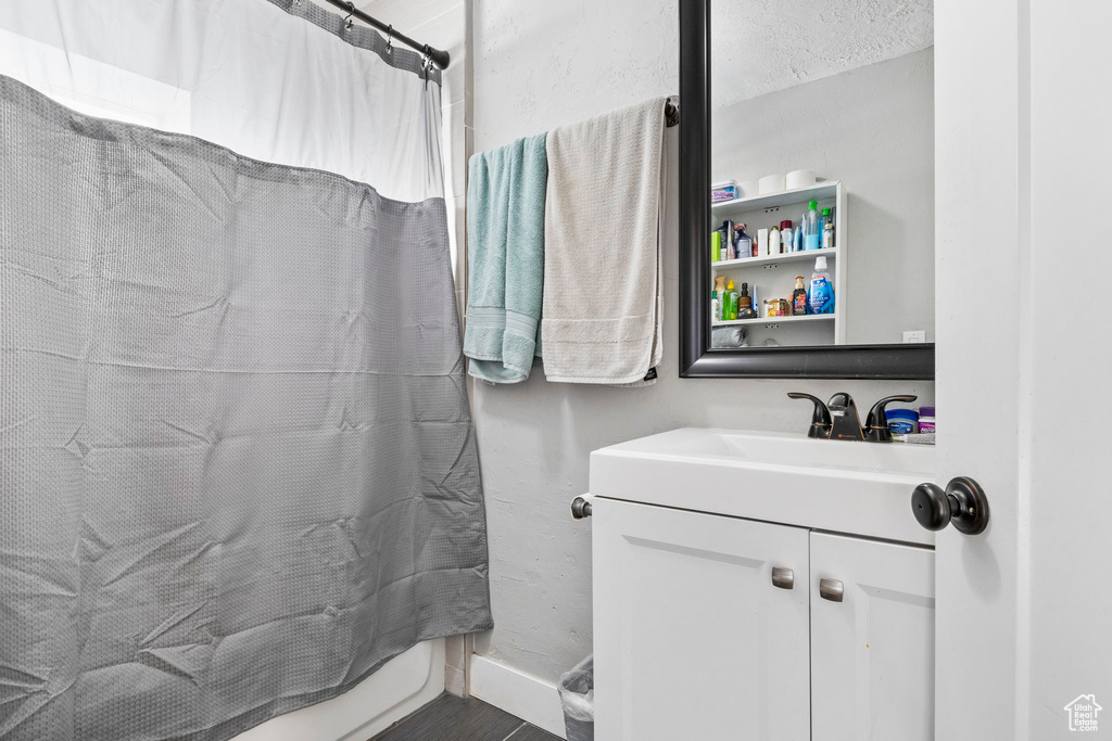 Bathroom featuring a shower with curtain, vanity, and a textured ceiling