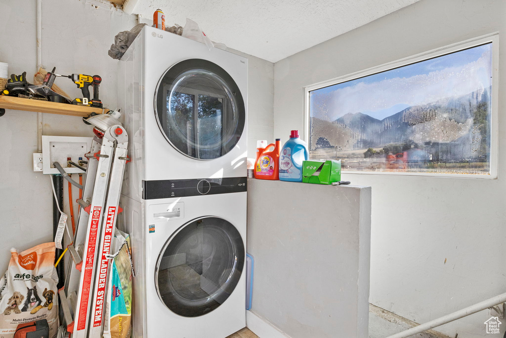 Laundry room with stacked washing maching and dryer