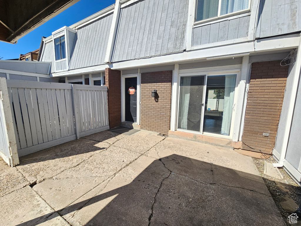 View of exterior entry with a patio area