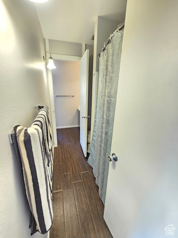 Hallway with dark hardwood / wood-style flooring