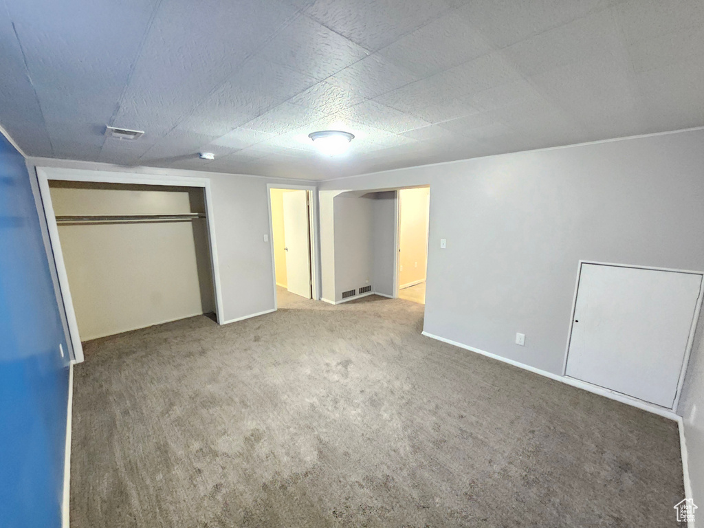 Unfurnished bedroom with carpet flooring