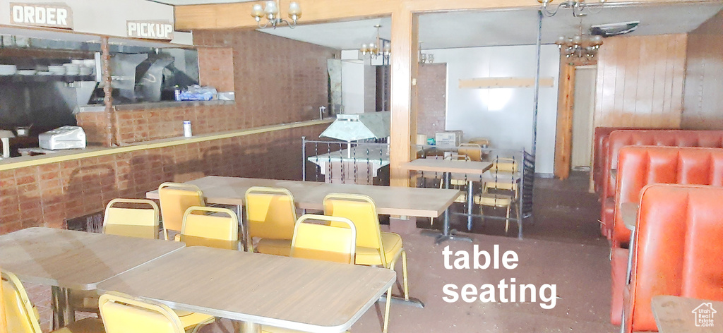 Dining area featuring wood walls