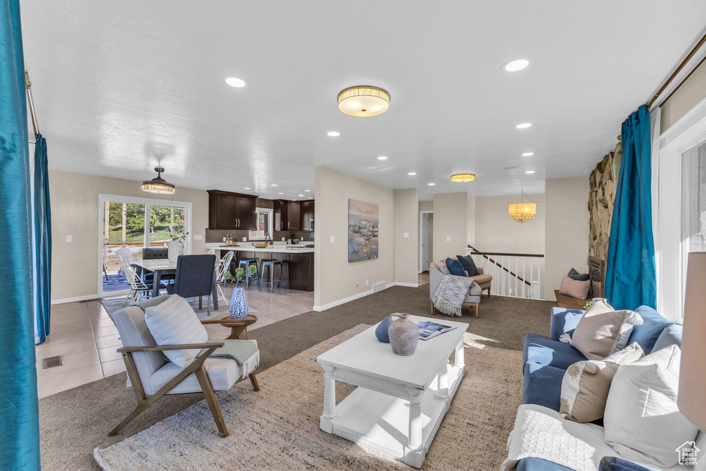 Tiled living room with a chandelier