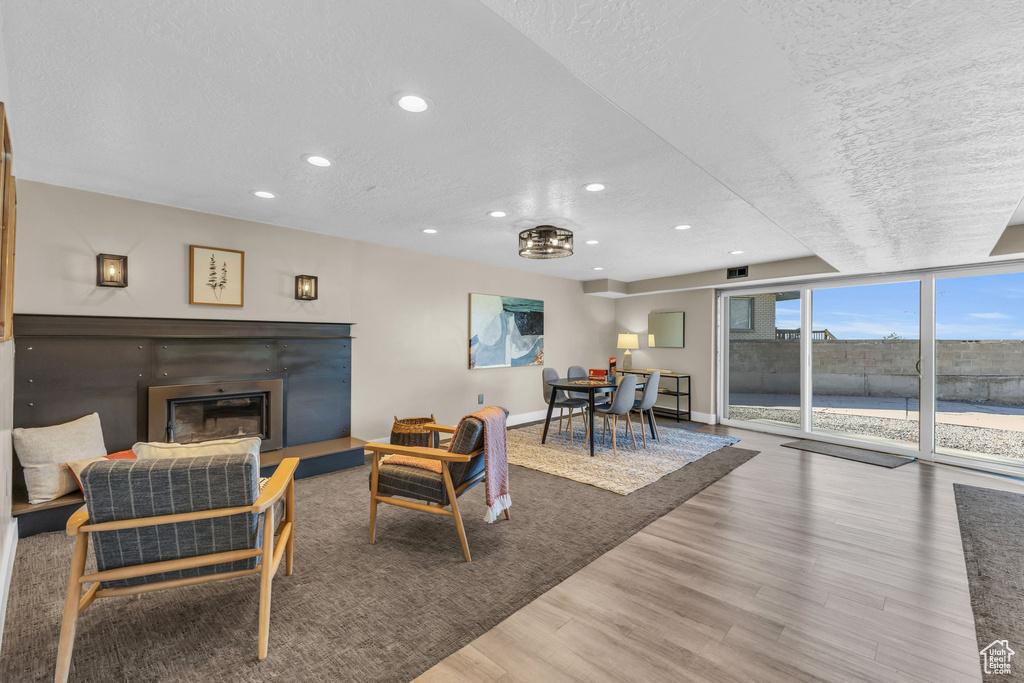 Living room featuring a textured ceiling and hardwood / wood-style floors