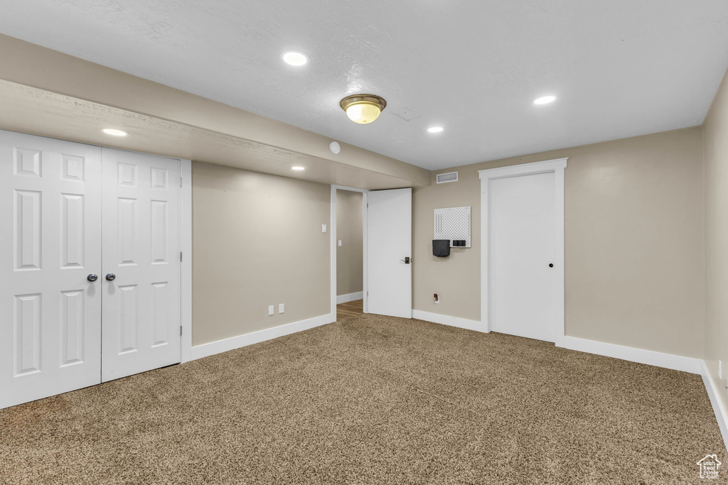 Basement featuring carpet