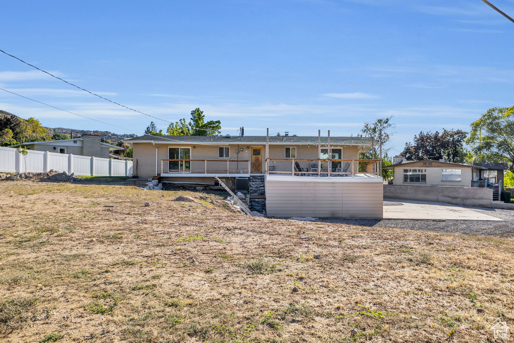 Rear view of house with a wooden deck