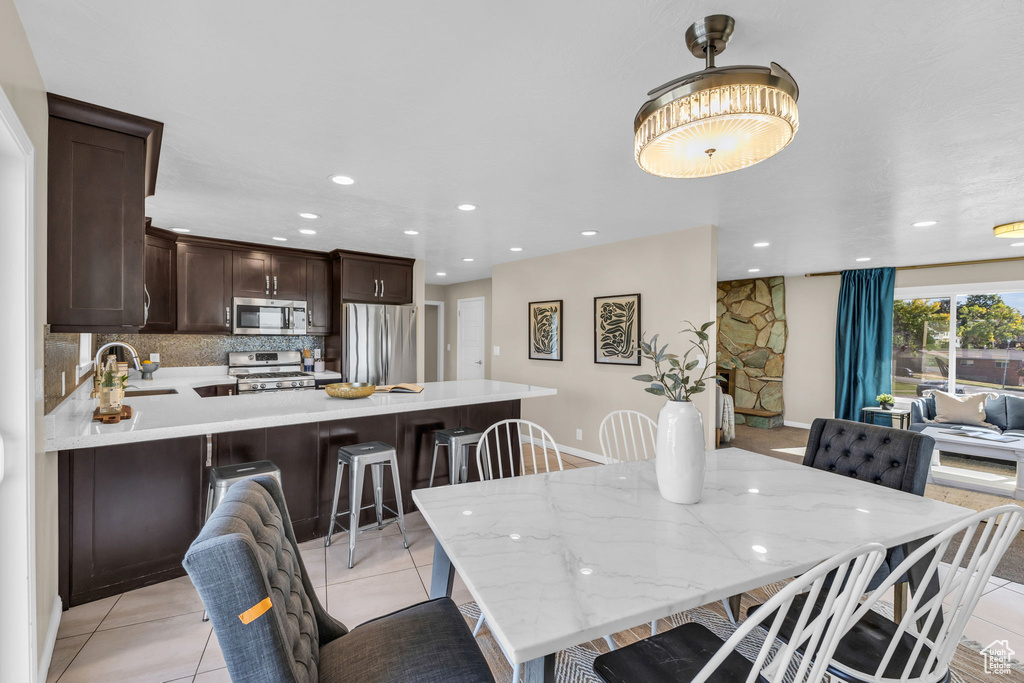 Tiled dining room with sink