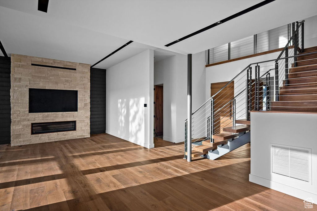 Unfurnished living room with hardwood / wood-style flooring and a fireplace