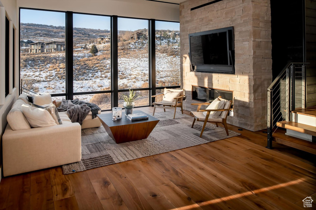 Living room with a fireplace and hardwood / wood-style floors