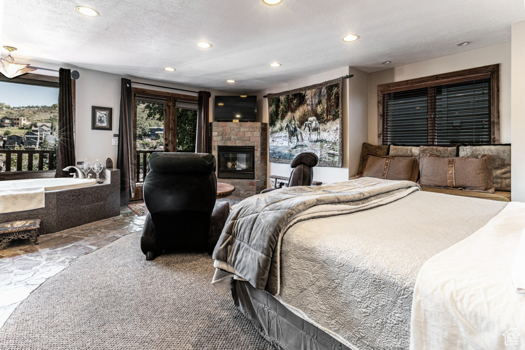 Bedroom with a textured ceiling and a tile fireplace