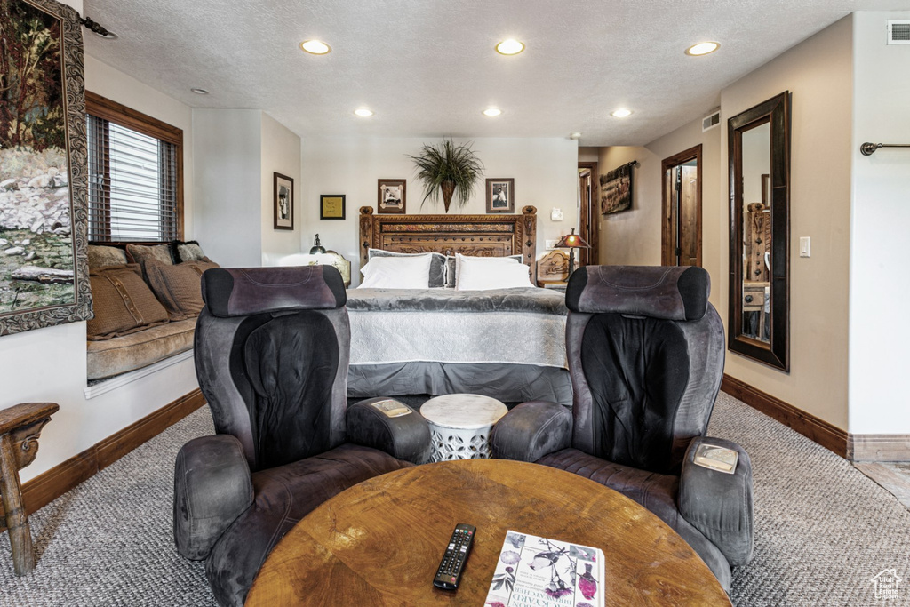 Carpeted bedroom featuring a textured ceiling