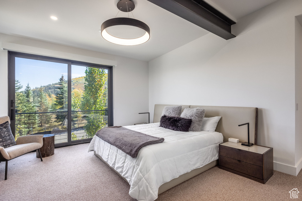 Bedroom with beamed ceiling and carpet floors