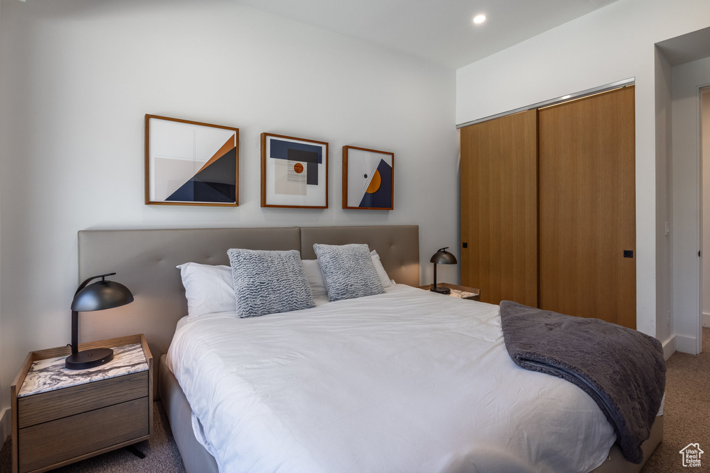 Bedroom featuring carpet and a closet