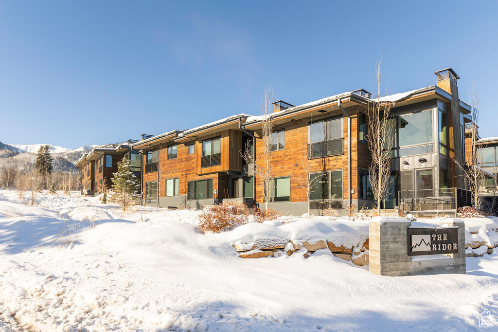 Snow covered property featuring a mountain view