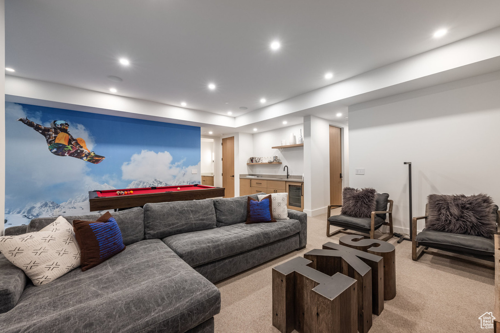 Living room with wine cooler, light colored carpet, wet bar, and pool table