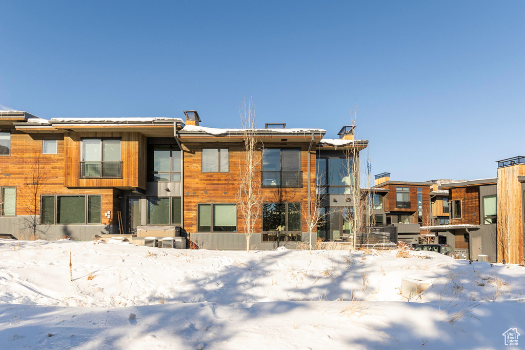 View of snow covered rear of property