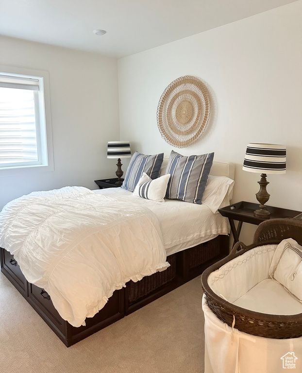 Bedroom featuring light carpet