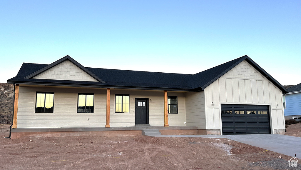 Modern farmhouse style home featuring a garage and covered porch