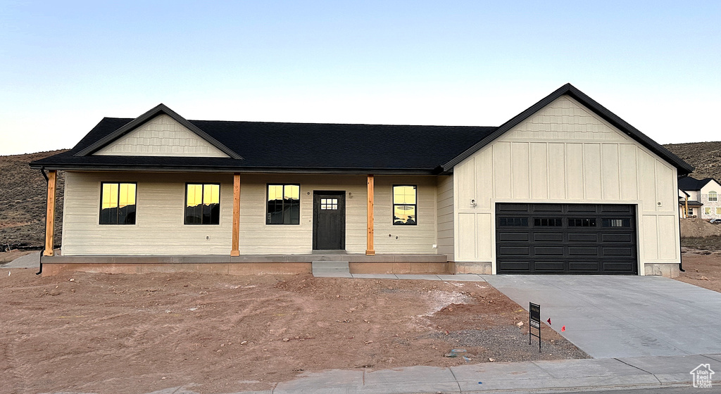 View of front of house featuring covered porch and a garage