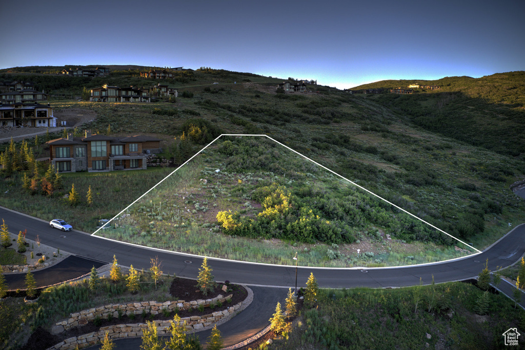 Aerial view of property's location featuring a mountainous background