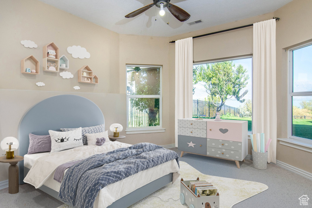 Bedroom featuring ceiling fan and carpet