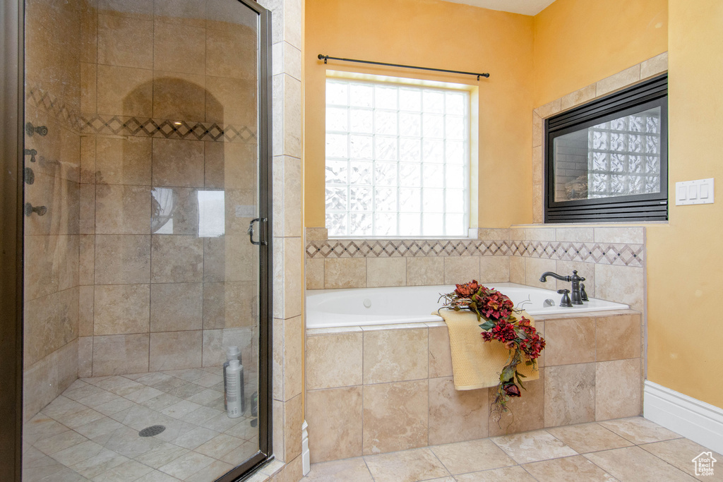 Bathroom with separate shower and tub and tile patterned floors