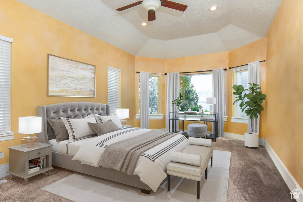 Bedroom with ceiling fan, a textured ceiling, lofted ceiling, and carpet