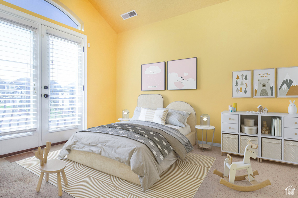 Bedroom with carpet flooring, vaulted ceiling, french doors, and access to exterior