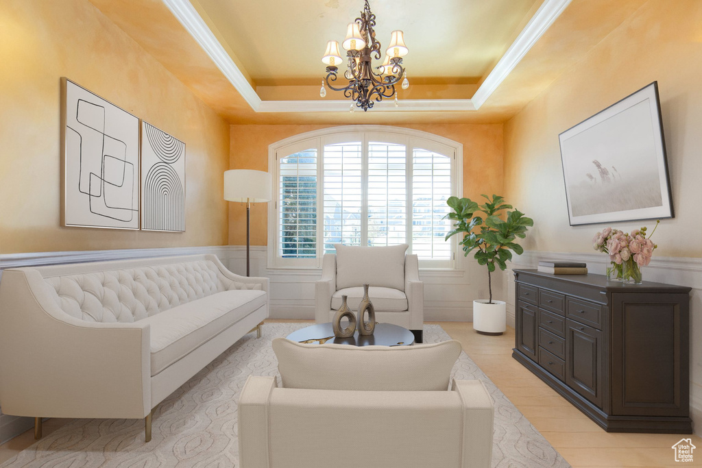 Sitting room featuring crown molding, a tray ceiling, and a notable chandelier