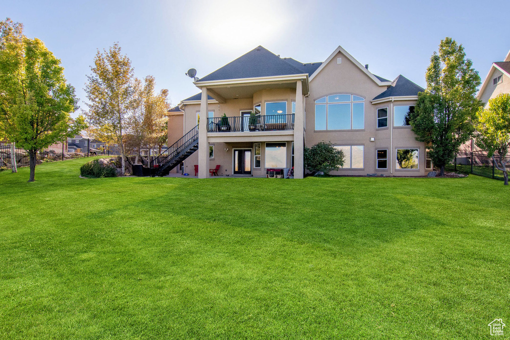 Rear view of house with a yard