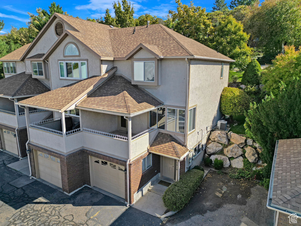 View of front of home featuring a balcony and a garage